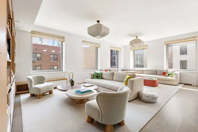 Living room at 116 University Place, Unit 5 with oversized windows and Village views.